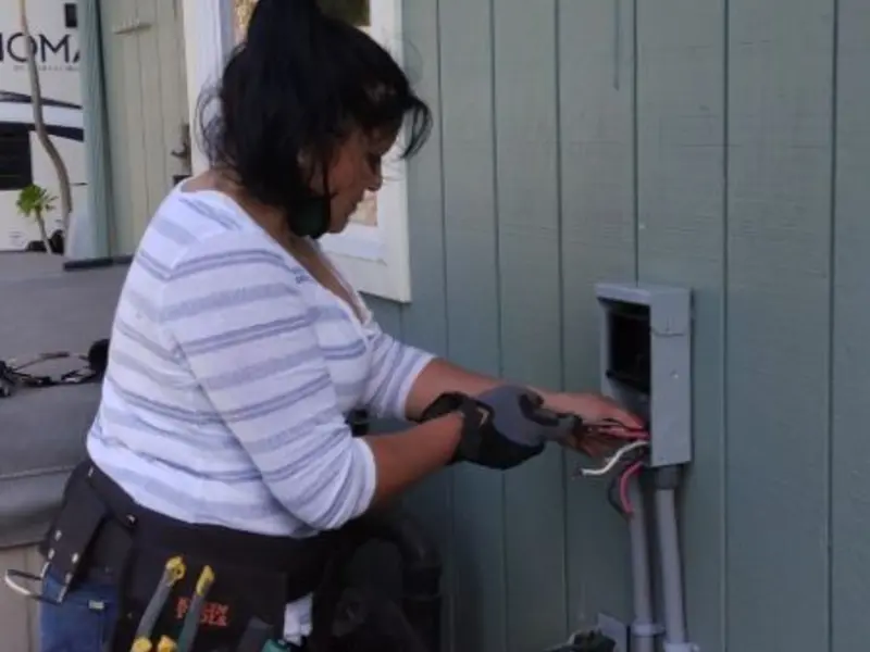 Licensed electrician wiring an exterior subpanel in Glendive